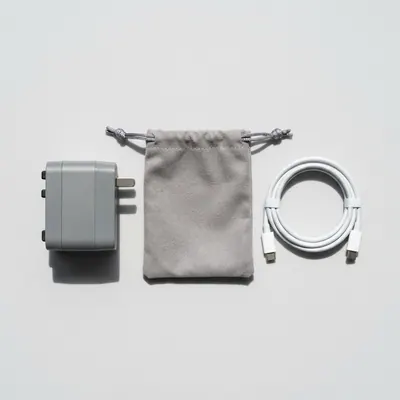 Travel adapter beside its soft pouch