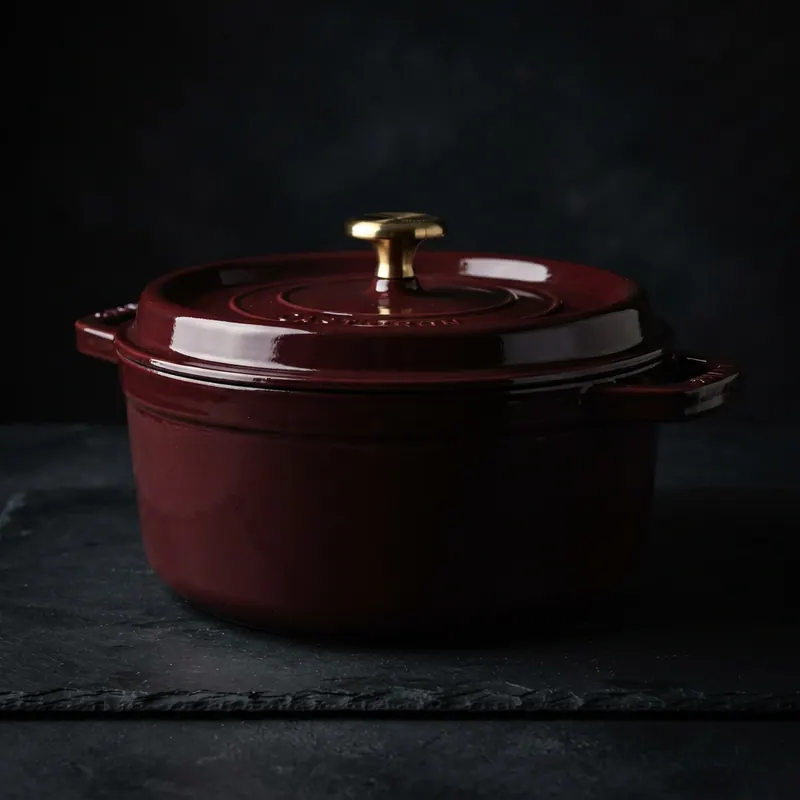 Maroon enamelled dutch oven, studio photograph