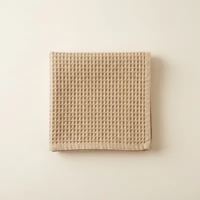 Linen sauna towel in sand, folded
