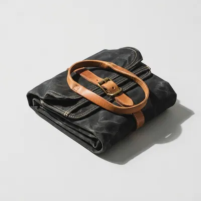 Fold Weekender folded flat beside its leather handles