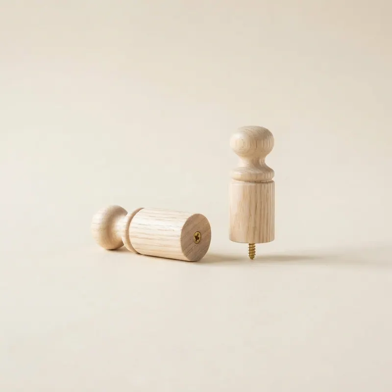 A pair of turned ash wood pegs